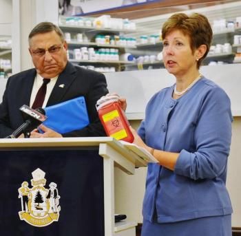 Patricia Aho, right, speaks at a recent event as Gov. Paul LePage watches. 