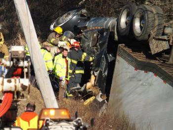 Firefighters from Dresden, Wiscasset and Richmond work to pry a driver from the cab of his tractor trailer after the rig rolled over into a ditch off Middle Road in Dresden Monday, Dec. 24. JOHN MAGUIRE/Wiscasset Newspaper