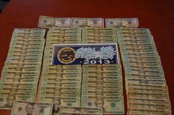 The Oxycodone and money seized during the arrest of Andrew Goupil and Joseph Dupaw, below.