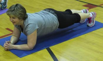  Patti Jo Averill holds a plank position during a “punishment” workout March 11. KATHY ONORATO/Wiscasset Newspaper