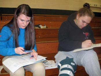 Juniors Abby Dunn, left, and Hannah Campbell work to figure out their future "financial fitness" using the materials and information provided by Maine's Credit Unions. Courtesy of Wiscasset High School Juniors Abby Dunn, left, and Hannah Campbell work to figure out their future "financial fitness" using the materials and information provided by Maine's Credit Unions. Courtesy of Wiscasset High School