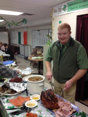 Lincoln County EMA/Communications Assistant Director Casey Stevens carves the ham. jOHN MAGUIRE/Wiscasset Newspaper