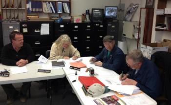 Woolwich selectmen sign the 2013 town meeting warrant on April 22. JOHN MAGUIRE/Wiscasset Newspaper