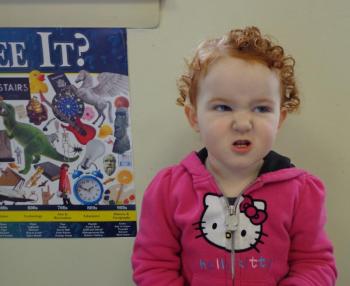 Shaylie, daughter of Brandie Robbins, demonstrates how a rabbit would wiggle its nose in an effort to catch the sweet smells of spring. Courtesy of Wiscasset Public Library
