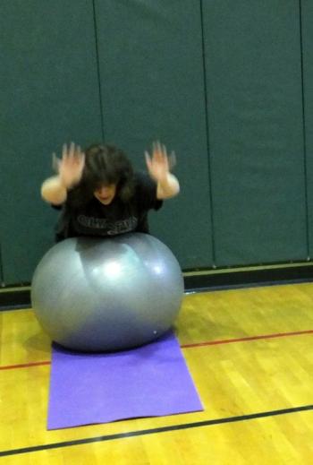 Rachael Fossett, above, and Cindy Carter, below, demonstrate the Superman exercise on the ball at the Week 5 Punishment Workout of Lisa Hall’s Weight Loss Challenge Monday, April 1. KATHY ONORATO/Wiscasset Newspaper