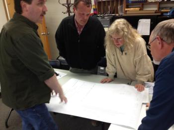 Resident Mike Ware and selectmen look over a preliminary plan for a proposed town office addition. JOHN MAGUIRE/Wiscasset Newspaper