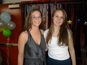 Student Council members Briana Goud and Sarah Hanley welcome students from four other high schools to the dance on April 26. Courtesy of Wiscasset High School