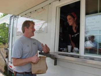 First-time customer Wayne Eugley of South Bristol picks up his order from Sea Digger's Grub co-owner Sydney Morin. SUSAN JOHNS/Wiscasset Newspaper