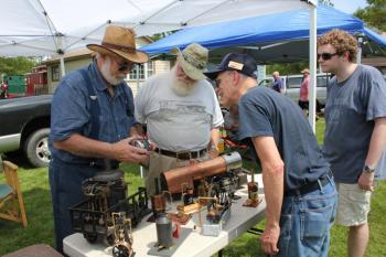 New England Model Engineering Society members Dick Boucher and Ron Ginger explain the inner workings of a scale model device. SUE MELLO/Boothbay Register