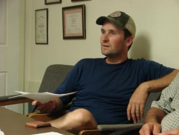 Alna Second Selectman Jonathan Villeneuve listens to Ralph Hilton as the two discuss Villeneuve's choice not to vote on the school budget. SUSAN JOHNS/Wiscasset Newspaper