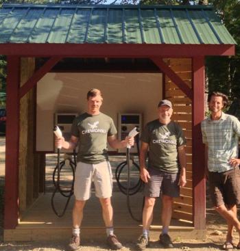 Showing off the new car charging station are, from left, Chewonki sustainability officer Tom Twist, technician Jamie Kane, and facilities manager Carob Arnold. Courtesy of Chewonki