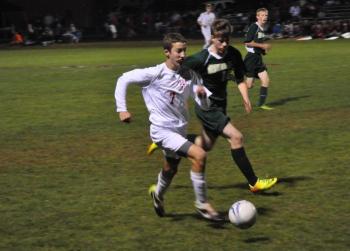 Mason Whitaker, left, tries to get the ball past a Winthrop defender. Wiscasset would win its homecoming game, 4-1, behind a goal from Whitaker. BEN BULKELEY/Wiscasset Newspaper