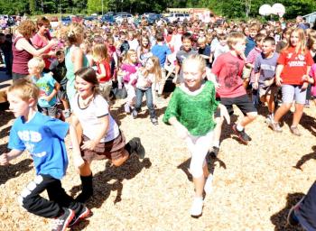 GREAT SALT Bay students sprint to the playground for the first time Friday, Sept. 6. The students of the school raised approximately $50,000 of the $100,000 needed to construct the new playground, which is adjacent to Great Salt Bay Community School. On Friday, there was a ribbon cutting and the students were able to enjoy the fruits of their labor. BEN BULKELEY/Boothbay Register
