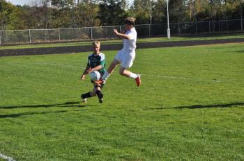 Aidan Carlson, right, grabs some air as he pursues the ball and a Spruce Mountain player. BEN BULKELEY/Wiscasset Newspaper