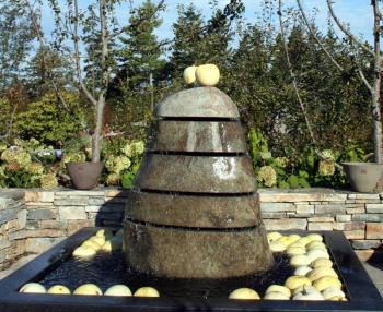 Are those bubbles floating in the Kitchen Garden fountain? No, they're albino pumpkins, just a few of the many tons of colorful gourds and pumpkins on display, along with scarecrows, at the Gardens this fall. Courtesy of Barbara Freeman