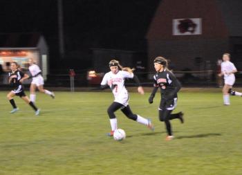 MAEVE CARLSON, center, outruns a Lisbon player Friday, Oct. 25. Carlson and the Wolverines would win a 1-0 thriller in overtime to advance in the Western Class C playoffs. BEN BULKELEY/Wiscasset Newspaper