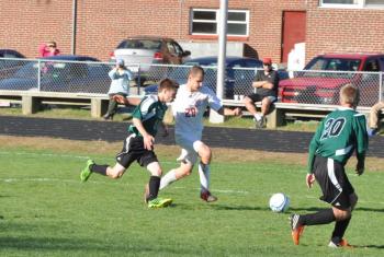 CAMDEN REISS, center, fights his way through Spruce Mountain’s defense in this October 8 file photo. Reiss and the Wolverines will look to continue their winning ways October 18 against Oak Hill. BEN BULKELEY/Wiscasset Newspaper