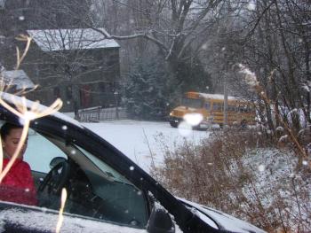A Dresden woman awaits a tow truck after the car she was driving down Alna’s Head Tide Hill went partly off the road the morning of November 26. Pictured further down the hill is a Regional School Unit 12 bus that was awaiting sand before climbing the hill. SUSAN JOHNS/Wiscasset Newspaper car and bus on Head Tide Hill in Alna