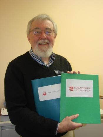 Boothbay Harbor Memorial Library Director Tim McFadden holds folders with passes to get into both the Portland Museum of Art and the Farnsworth Art Museum in Rockland. SUSAN JOHNS/Wiscasset Newspaper Boothbay Harbor Memorial Library Director Tim McFadden