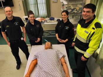 Standing in the Boothbay Region Ambulance Service simulation lab are, from left, Operations Manager and Paramedic Scott Lash, Paramedic Katie Hudson, Advanced Emergency Medical Technician Kerri Dupre and Emergency Medical Technician James Bodman. These Boothbay Region Ambulance Service members have pulled together to better practice their skills. Courtesy of LincolnHealth