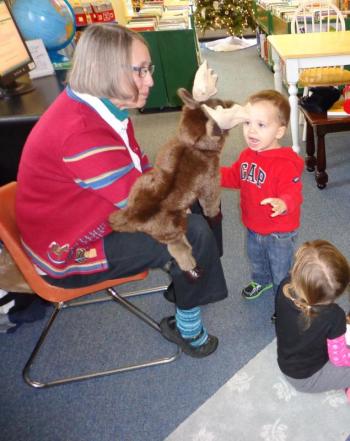Wendy Ulmer and moose puppet Joe read the children a story. Courtesy of Natalie Castonia