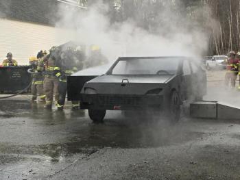 Opening the car door to spray inside. The car gets “wicked hot,” according to Deputy Director Jim Graves of the MFSI. KATRINA CLARK/Boothbay Register