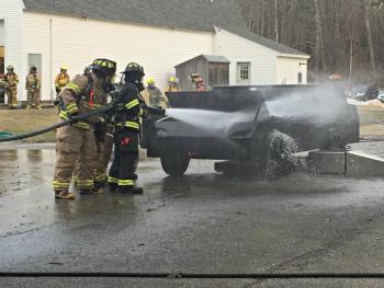 Spraying under the hood of the prop car. KATRINA CLARK/Boothbay Register