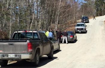 Law enforcement authorities and vehicles line Quarry Farm Road in Edgecomb outside the home of missing woman Lynne Crink on Sunday, April 19. SUZI THAYER/Boothbay Register