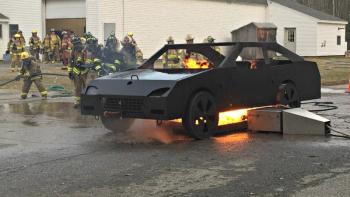 A team of firefighters approaches the blazing car during car fire training on April 16. KATRINA CLARK/Boothbay Register