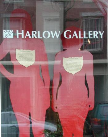 “Silent Witnesses” in the Harlow Gallery window in October of 2005 for the first “Transforming Violence” exhibition. The Maine Silent Witness Project honors those who died as a result of domestic violence. Life size silhouettes, composed of wood, were painted red and bore a gold shield relating each woman’s name and experience. Courtesy of Deborah Fahy Silent Witnesses in the Harlow Gallery window 2005