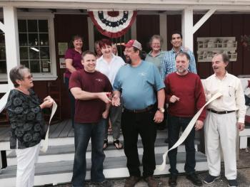 From left, Wiscasset Selectmen’s Vice Chairman Judy Flanagan, Wiscasset Village Antiques co-owners Rick Moore and Danny Lester, Selectmen’s Chairman Ben Rines Jr. and Selectman David Cherry carry out the Route 1 business’ ribbon-cutting on July 24. Wiscasset Area Chamber of Commerce members and other well-wishers joined them. SUSAN JOHNS/Wiscasset Newspaper Wiscasset Village Antiques, Rick Moore, Danny Lester, Judy Flanagan, David Cherry, Ben Rines Jr.