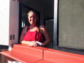 Christine Schweighauser's smile is almost as big as her portions, as she welcomes people to her new food stand on Main Street in Damariscotta, The Cook’s Corner. SUZI THAYER/Boothbay Register
