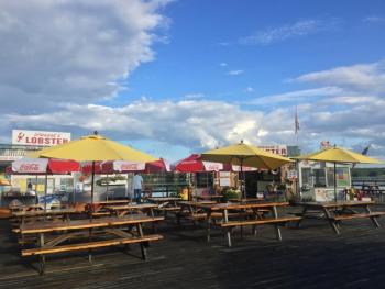 Tables with umbrellas on a wharf over Wiscasset harbor at Sprague’s Lobster can accommodate over 100 happy customers. SUZI THAYER/Wiscasset Newspaper
