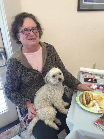 Gail Burke of Wiscasset attends Oktoberfest at First Congregational Church in Wiscasset on Oct. 3 with her toy poodle mix Annie. Annie tried a potato chip but had not sampled the bratwurst, Burke said. SUSAN JOHNS/Wiscasset Newspaper Gail Burke, Oktoberfest, First Congregational Church, Wiscasset