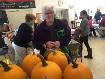 Katharine Martin-Savage of Wiscasset picks out a pumpkin to buy at Oktoberfest on Oct. 3, inside First Congregational Church in Wiscasset. SUSAN JOHNS/Wiscasset Newspaper Katharine Martin-Savage, Oktoberfest, First Congregational Chuch, Wiscasset