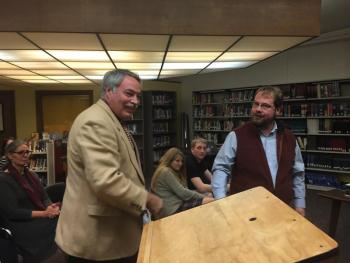 Retiring Wiscasset music teacher Roger Whitney, left, and School Committee Chairman Steve Smith finish shaking hands at the committee’s Oct. 29 meeting. SUSAN JOHNS/Wiscasset Newspaper Roger Whitney, Steve Smith