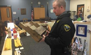 Correctional Officer Terry Marks looks over a potential Christmas gift at Two Bridges Regional Jail’s craft fair Nov. 28. SUSAN JOHNS/Wiscasset Newspaper