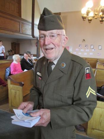 In his former U.S. Army uniform, Lloyd Coombs, Woolwich selectman and former town administrator, greets those attending the town’s Veterans Day ceremony. Coombs served as an Army corporal from 1957 to 1959. About the program, Coombs said it was nice to see so many young people in attendance. PHIL DI VECE/Wiscasset Newspaper Lloyd Coombs