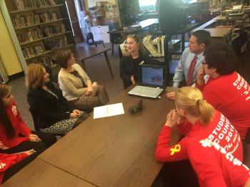 Julie Guerrette of Good Shepherd Food Bank, speaking, and, right, News 13 anchor Jeff Peterson meet with Wiscasset School Department staff and students Nov. 17 in the Wiscasset Middle High School library. SUSAN JOHNS/Wiscasset Newspaper