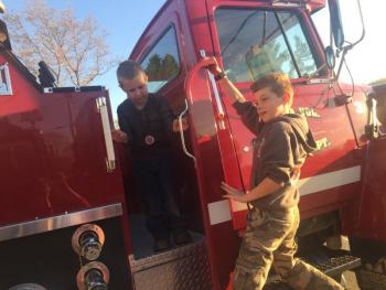 Gabriel GaNun, 5, left, and Austin Trask, 10, play tag on a fire truck during a May 18 open house at the Alna fire station. SUSAN JOHNS/Wiscasset Newspaper