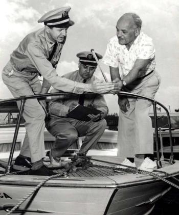 The uniforms may have changed but the USCG Auxiliary still checks the bow light as part of a free Vessel Safety Check or VSC for recreational boaters. The VSC process includes every item that will be checked if boarded by the Coast Guard, no fines will be levied or reports filed; the inspection results are confidential and serve only to give the boater a list of any items that may need repair or replacement. Courtesy of USCG Auxiliary archives