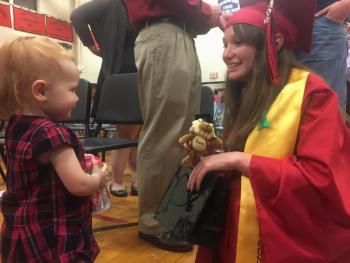 Class of 2016 member Alisyn Richardson, right, meets with cousin Cecily LeRoy, 16 1/2 months, after commencement. SUSAN JOHNS/Wiscasset Newspaper