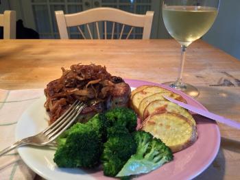 A pork chop, pan fried with Morse’s sauerkraut, some roasted Yellow Gold potatoes, steamed broccoli with olive oil and garlic, and a glass of cold chardonnay, made for a scrumptious dinner in the Thayer household. SUZI THAYER/Boothbay Register