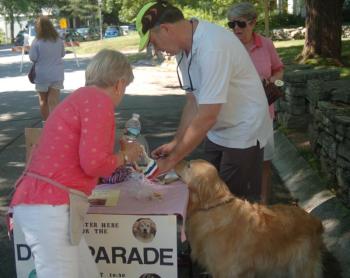 Chris Sieracki signs up an eager canine and its master for the dog parade. ART MAYERS/Wiscasset Newspaper