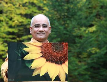 Dr. Rifat Zaidi with a photo of a sunflower that will be on display at the Miles Campus of LincolnHealth from Nov. 26 through Christmas. The photographs are printed on aluminum, a much more durable medium than paper prints. All funds from sale of the photographs will go toward building a school for girls in a deeply impoverished area in Pakistan. Courtesy photo