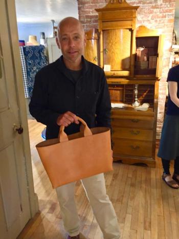 Richard Grenier from Gloucester, Massachusetts, holds one of his handmade leather bags that will be featured at the Marston House in the spring. SUZI THAYER/Boothbay Register
