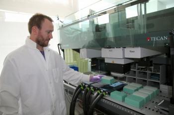 Brian Thompson, a research associate in the Single Cell Genomics Center at Bigelow Laboratory for Ocean Sciences, loads samples into a liquid handling robot. The Laboratory recently published the details of significant advances in single cell genomics technology, which allows scientists to study the genes of individual cells. Courtesy of Bigelow Laboratory