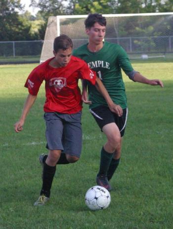Josh Gabriele goes shoulder-to-shoulder with Temple’s Will Paradis, who scored three times. PHIL DI VECE/Wiscasset Newspaper