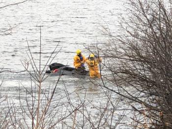 Rockport firefighters put on their cold water rescue gear this evening, March 23, to enter Chickawaukie Lake, in Rockport, to ensure no other victims were in the Jeep Grand Cherokee that landed in the water this evening, after leaving the Route 17 highway. (Photo courtesy Rockport Fire Department)
