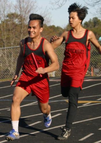 Chris Loyola takes the handoff from brother Cedrick in the 4x100-meter relay race won by Wiscasset. PHIL DI VECE/Wiscasset Newspaper